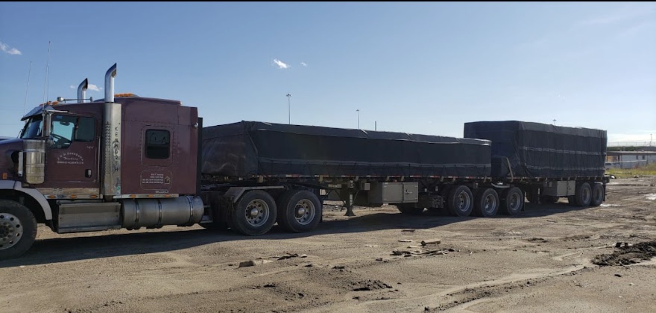 J & M Randhawa Super B-train flatbed tarped with two-trailer configuration